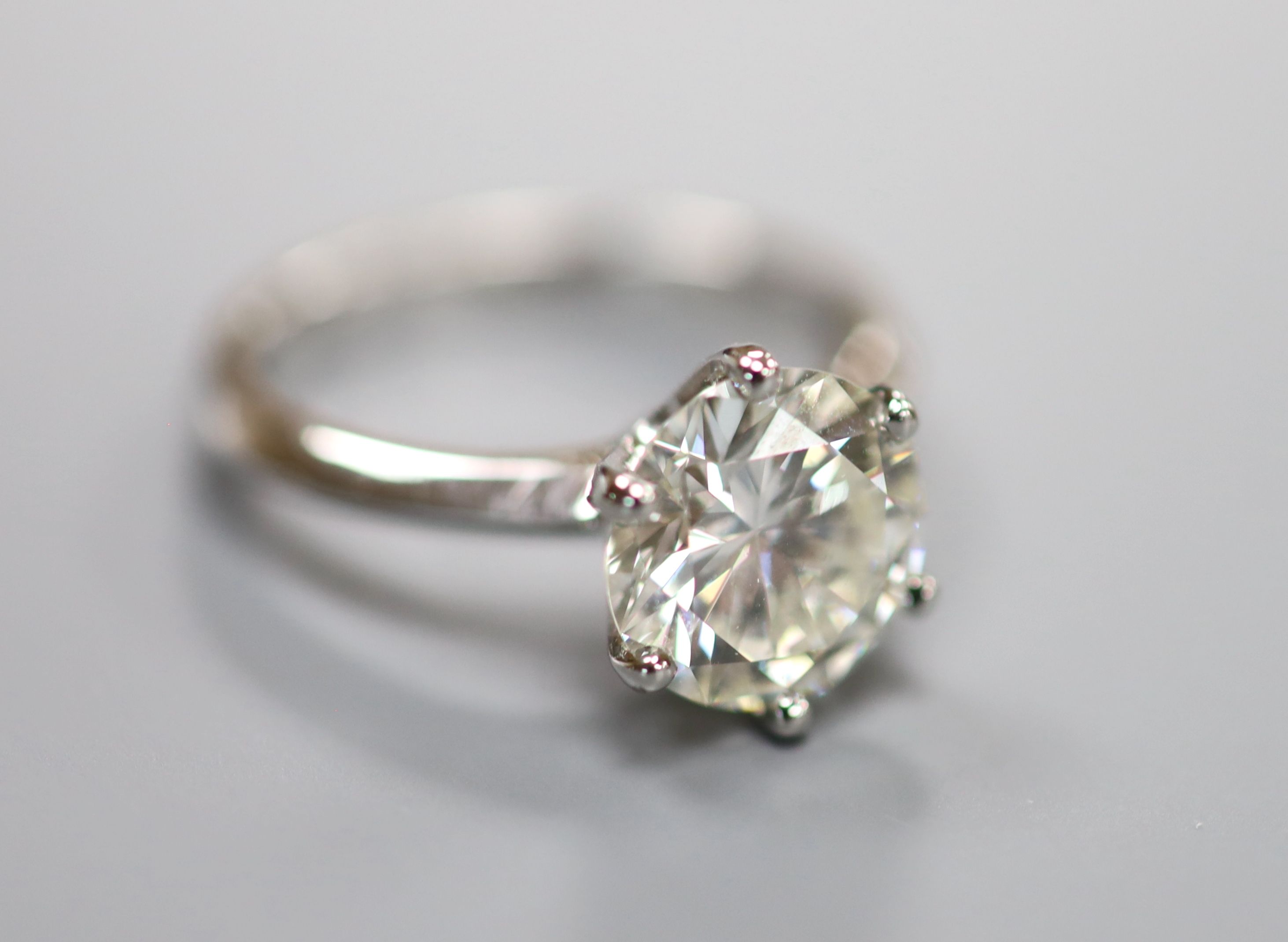 A modern platinum and solitaire diamond ring,